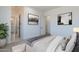 Cozy bedroom with neutral decor, carpet, and an open doorway to an ensuite bathroom at 9318 E Cloudview Ave, Gold Canyon, AZ 85118