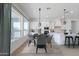 Open dining area with large windows providing natural light next to a modern, white kitchen at 9318 E Cloudview Ave, Gold Canyon, AZ 85118