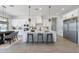 Bright kitchen features a large island with seating, stainless steel appliances, and white cabinetry at 9318 E Cloudview Ave, Gold Canyon, AZ 85118