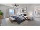 Well-lit bedroom featuring a comfortable bed, soft carpet, and a view into the main bathroom at 9318 E Cloudview Ave, Gold Canyon, AZ 85118