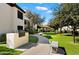 Outdoor BBQ area with grill, bench, and sidewalks, nestled amidst mature trees and manicured lawns at 9990 N Scottsdale Rd # 2020, Paradise Valley, AZ 85253