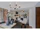 Charming dining area with a modern chandelier and convenient access to the living room and kitchen at 9990 N Scottsdale Rd # 2020, Paradise Valley, AZ 85253