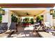 Inviting covered patio with lounge chairs and ceiling fan overlooking the community pool at 9990 N Scottsdale Rd # 2020, Paradise Valley, AZ 85253