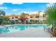 Resort-style community pool with lounge chairs surrounded by lush landscaping and palm trees at 9990 N Scottsdale Rd # 2020, Paradise Valley, AZ 85253