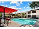 Relaxing community pool with lounge seating and shade umbrellas for hot summer days at 9990 N Scottsdale Rd # 2020, Paradise Valley, AZ 85253