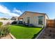 This backyard includes low-maintenance turf and an outdoor kitchen perfect for relaxing and entertaining at 1018 S 5Th St, Avondale, AZ 85323