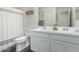 This bathroom offers a double vanity, offering convenience, storage, and a clean, modern aesthetic at 1018 S 5Th St, Avondale, AZ 85323