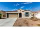 Well-maintained single-story home featuring a two-car garage, desert landscaping, and a welcoming entrance at 1018 S 5Th St, Avondale, AZ 85323