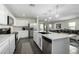 Spacious open kitchen featuring stainless steel appliances, large island, and sleek white cabinetry at 1018 S 5Th St, Avondale, AZ 85323