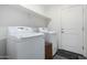 This laundry room includes a washer, dryer, and storage shelf for convenient laundry care at 1018 S 5Th St, Avondale, AZ 85323