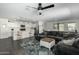 Open-concept living room and kitchen area with large gray sectional sofa and a view of the modern kitchen at 1018 S 5Th St, Avondale, AZ 85323