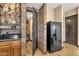 Bar area open to wine cellar with wine racks and a black stainless refrigerator at 10224 N Azure Vista Trl, Fountain Hills, AZ 85268