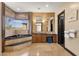 Luxurious bathroom featuring a soaking tub with a view, double sinks, and a vanity area at 10224 N Azure Vista Trl, Fountain Hills, AZ 85268