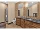 Bathroom featuring dual mirrors, decorative tile backsplash, a full vanity, and a glass enclosed shower with neutral tiling at 10224 N Azure Vista Trl, Fountain Hills, AZ 85268