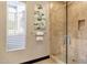 Bathroom with glass shower, neutral-toned tiling, and bright window at 10224 N Azure Vista Trl, Fountain Hills, AZ 85268