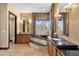 Elegant bathroom with dual vanities, a soaking tub, and large windows offering natural light at 10224 N Azure Vista Trl, Fountain Hills, AZ 85268