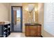 Bathroom features a wood vanity with granite countertop, outside door and window at 10224 N Azure Vista Trl, Fountain Hills, AZ 85268