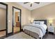 Cozy bedroom featuring a bathroom view through a dark wood trimmed entry and a comfortable bed with stylish details at 10224 N Azure Vista Trl, Fountain Hills, AZ 85268