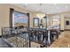 Elegant dining room featuring a decorative chandelier, large windows with stunning views, and stylish wrought iron stair railings at 10224 N Azure Vista Trl, Fountain Hills, AZ 85268