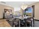 Elegant dining room with a grand chandelier, a modern table setting, and picturesque views from the expansive windows at 10224 N Azure Vista Trl, Fountain Hills, AZ 85268