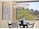 Dining area with modern chandelier, table setting, and beautiful backyard view at 10224 N Azure Vista Trl, Fountain Hills, AZ 85268