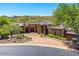 Stunning desert home with stone accents, circular driveway, and manicured landscaping in a beautiful natural setting at 10224 N Azure Vista Trl, Fountain Hills, AZ 85268