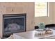 Close-up shot of a modern stone fireplace with decorative accessories and a view of the scenic desert landscape at 10224 N Azure Vista Trl, Fountain Hills, AZ 85268