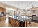 Large kitchen island with bar stool seating and open floor plan to living room at 10224 N Azure Vista Trl, Fountain Hills, AZ 85268