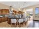 Open kitchen layout with granite island, seating, pendant lighting, and stainless steel hood at 10224 N Azure Vista Trl, Fountain Hills, AZ 85268