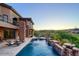 Stunning home exterior boasting a serene pool with cascading waterfalls, perfect for relaxation and outdoor enjoyment at 10224 N Azure Vista Trl, Fountain Hills, AZ 85268