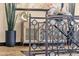 Close-up view of the wrought iron staircase with decorative glass, a modern cabinet, and artistic decor accents at 10224 N Azure Vista Trl, Fountain Hills, AZ 85268