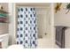 Bright bathroom with a shower featuring a decorative blue floral curtain at 10511 W Wheatridge Dr, Sun City, AZ 85373