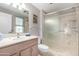 The bathroom features a shower, a toilet, a window, and a vanity sink at 10511 W Wheatridge Dr, Sun City, AZ 85373