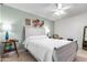 Bright bedroom with a ceiling fan, lamps, and a comfortable rocking chair at 10511 W Wheatridge Dr, Sun City, AZ 85373