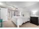 Primary bedroom with a view to the en suite, ceiling fan and white furnishings at 10511 W Wheatridge Dr, Sun City, AZ 85373