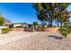 Community entrance featuring manicured landscaping, a brick wall, and a private walkway at 10511 W Wheatridge Dr, Sun City, AZ 85373