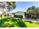 Manicured lawns and mature trees accent this community with a warm inviting exterior at 10511 W Wheatridge Dr, Sun City, AZ 85373