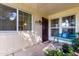 Inviting front porch with decorative bench and potted plants, creating a cozy entrance at 10511 W Wheatridge Dr, Sun City, AZ 85373