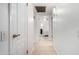 Hallway view into a bedroom with white furnishings and a ceiling fan at 10511 W Wheatridge Dr, Sun City, AZ 85373