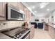 Bright kitchen with stainless steel appliances and a view to the Gathering room at 10511 W Wheatridge Dr, Sun City, AZ 85373