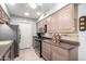 Galley kitchen with stainless steel appliances, abundant cabinet space, and stylish countertops at 10511 W Wheatridge Dr, Sun City, AZ 85373