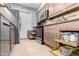 Charming kitchen featuring stainless appliances, cabinetry with pull-out shelving, and custom backsplash at 10511 W Wheatridge Dr, Sun City, AZ 85373