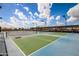 Outdoor pickleball courts with green and blue surfaces, surrounded by fencing, under a bright, cloudy sky at 10511 W Wheatridge Dr, Sun City, AZ 85373