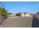 Backyard with gravel landscaping, surrounded by a white fence at 10650 W Riviera Dr, Sun City, AZ 85351