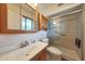 Bathroom with a single sink vanity, toilet, and glass door shower at 10650 W Riviera Dr, Sun City, AZ 85351