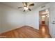 Bedroom features hardwood floors, a ceiling fan, closet, and access to the bathroom at 10650 W Riviera Dr, Sun City, AZ 85351