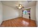 Bedroom showcasing hardwood floors, brick wall, and a window with patterned curtains at 10650 W Riviera Dr, Sun City, AZ 85351