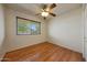 A bedroom with hardwood floors, a ceiling fan, and natural light at 10650 W Riviera Dr, Sun City, AZ 85351