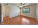 Light-filled bedroom features hardwood floors, a ceiling fan, and ample closet space at 10650 W Riviera Dr, Sun City, AZ 85351