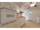 Bright kitchen features an oven, white cabinetry, and pink countertop accents at 10650 W Riviera Dr, Sun City, AZ 85351